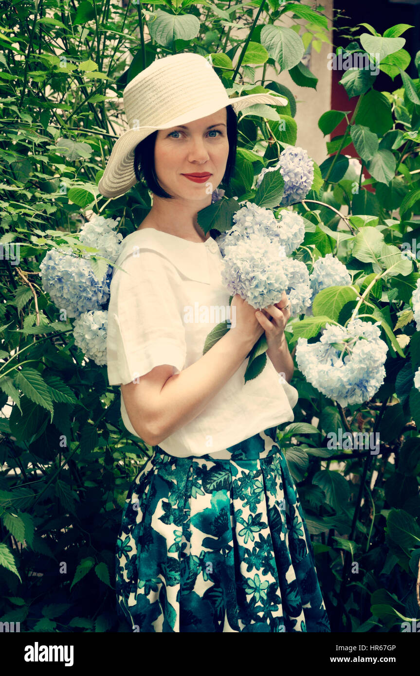 Portrait of a beautiful woman in flower garden Stock Photo