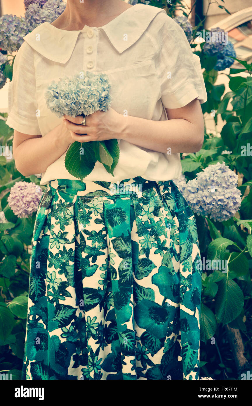 Portrait of a beautiful woman in flower garden Stock Photo