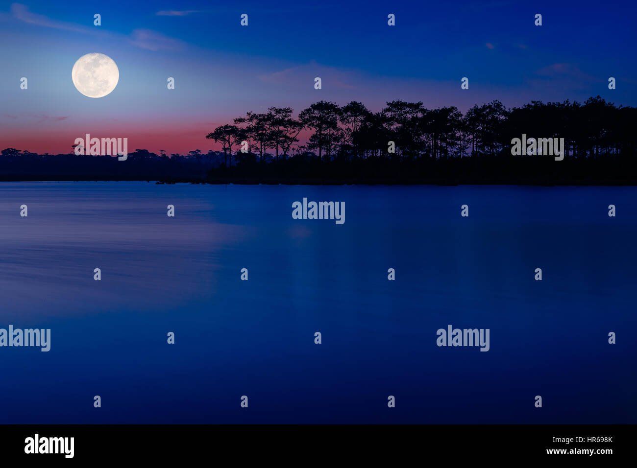 Moon on night sky over winter lake at night time Stock Photo - Alamy