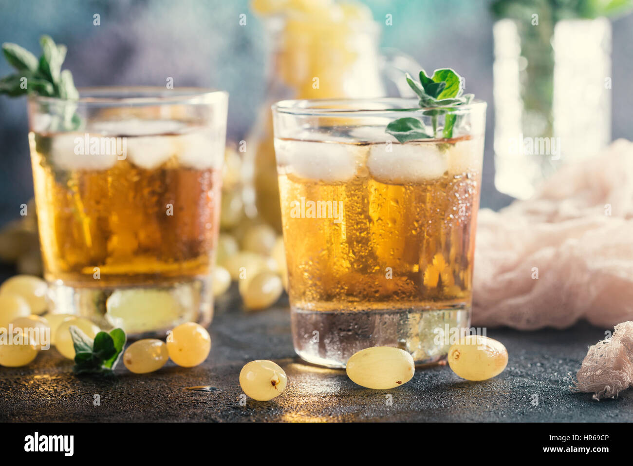 Two glasses of green grape juice with fresh fruits and Oregano Stock