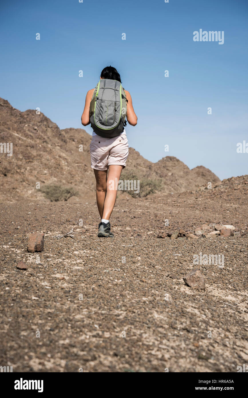 Woman trekking in a Wadi (Dry mountains) Stock Photo