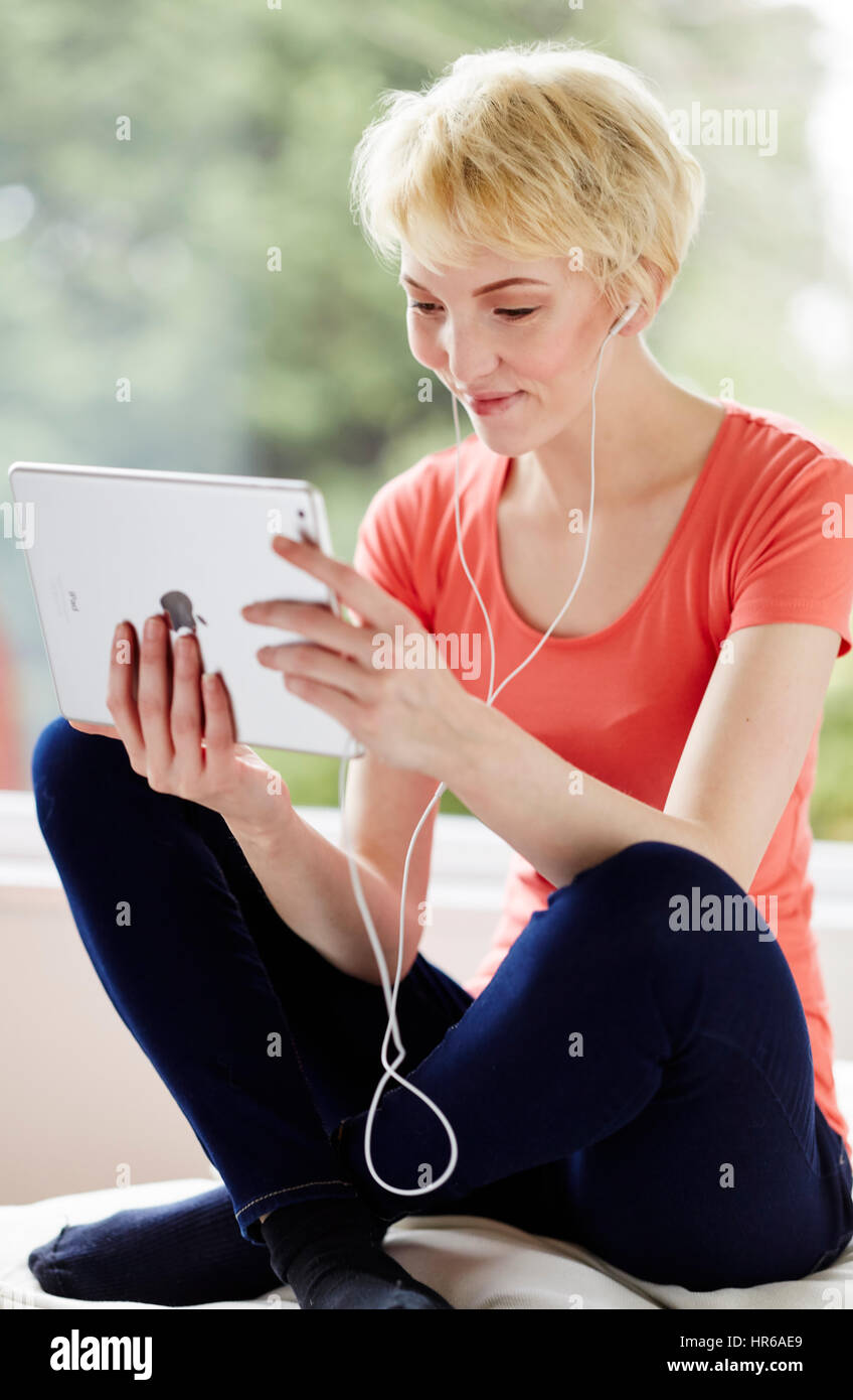 Girl relaxing using her iPad Stock Photo