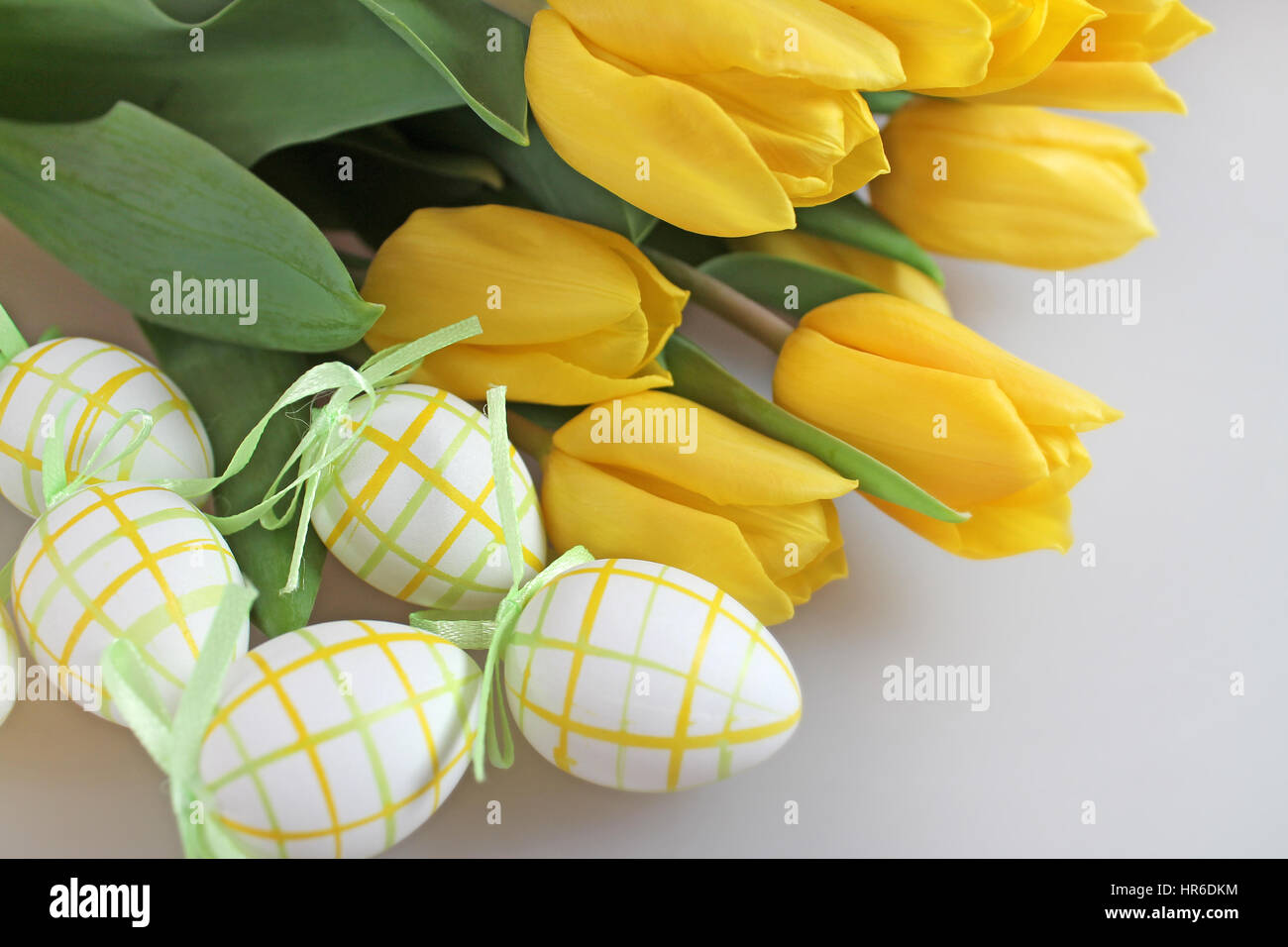 Easter eggs and yellow tulips Stock Photo - Alamy