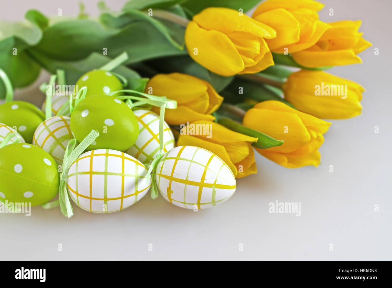 Easter eggs and yellow tulips Stock Photo - Alamy