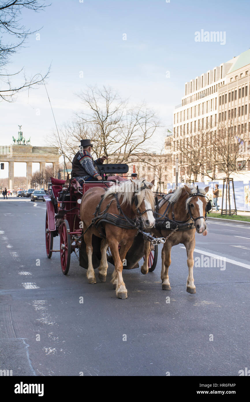 Horsedrawn carriage with tourists near the Brandenburg Gate. Berlin