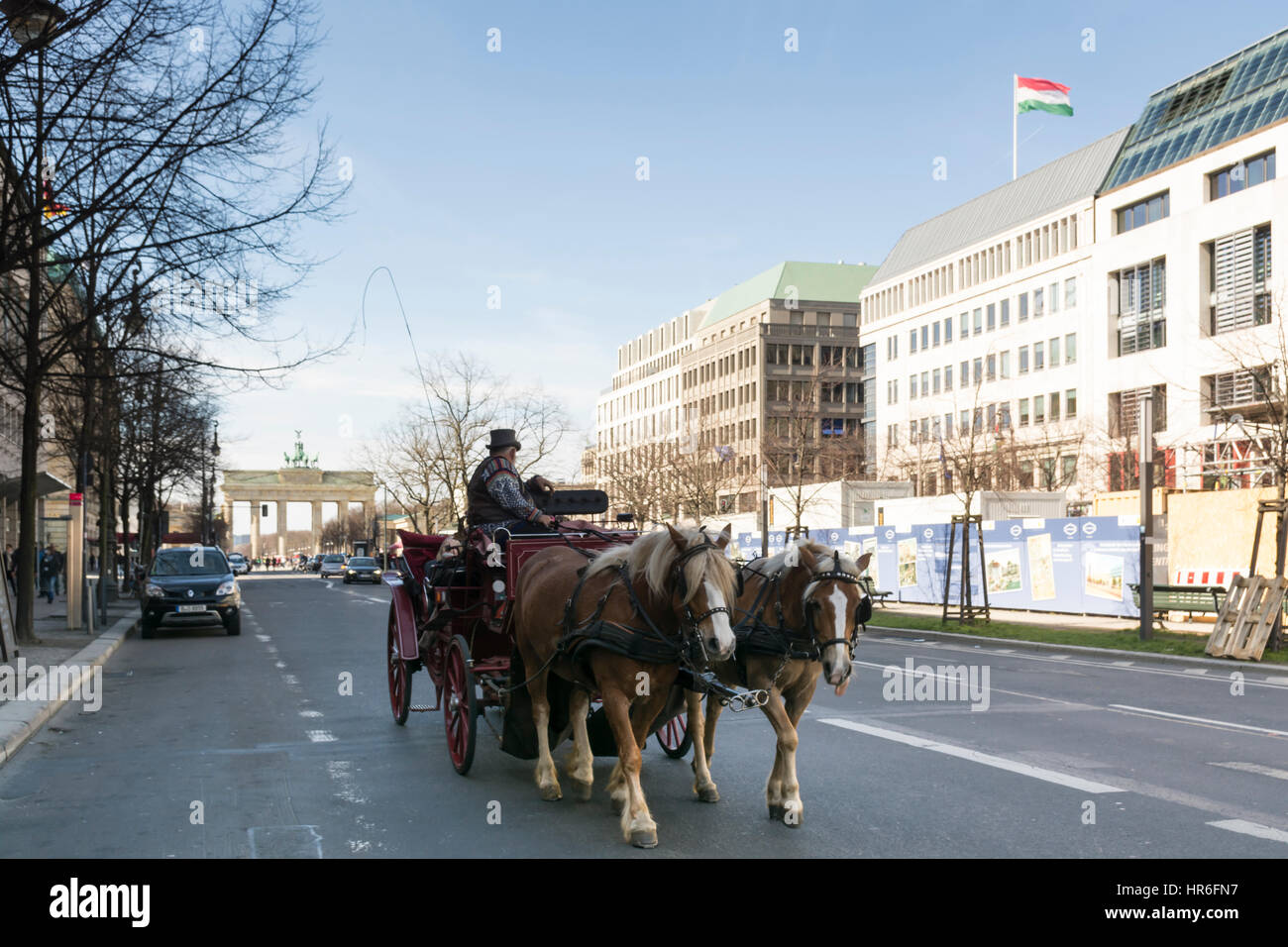 Horse-drawn carriage with tourists near the Brandenburg Gate. Berlin, Germany Stock Photo