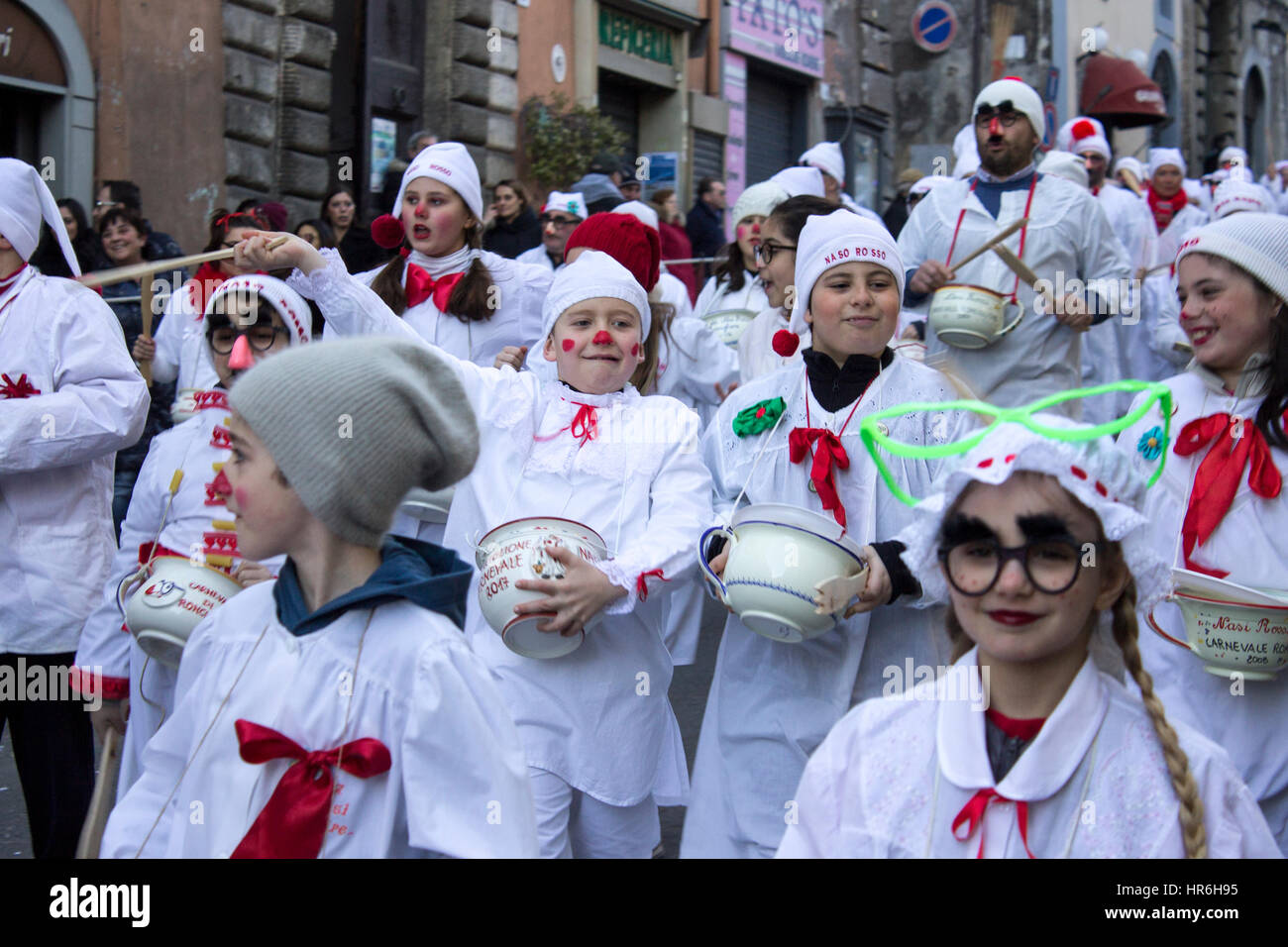 Ronciglione, Italy. 27th Feb, 2017. The red nose is a historic carnival mask of Ronciglione town. The red noses are night dresses with sattana and cap and roam the city with a full chamber pot of rigatoni with sauce that give citizens. Credit: Elisa Bianchini/Pacific Press/Alamy Live News Stock Photo