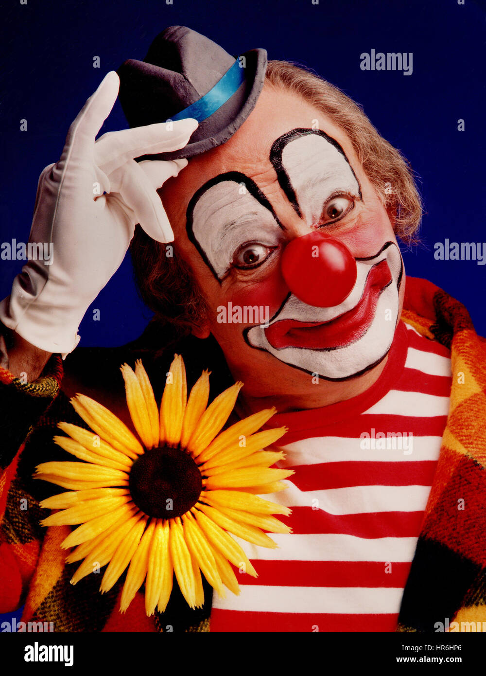 Clown poster colourful circus costume with traditional red nose posing for a studio photograph to promote via POS dealer poster display Kodak negative colour film 1970’s /1980’s Ian Shaw Kodak Photographer Stock Photo