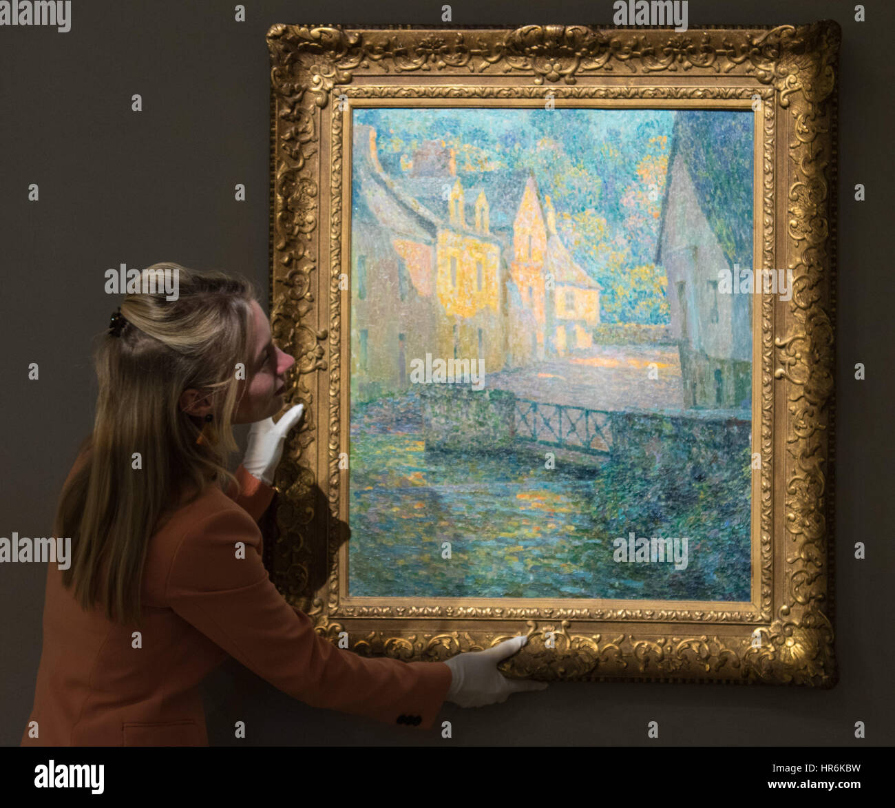 Bonhams, London, February 27th 2017. A member of Bonham's staff straightens Henri Le Sidaner's 'Matin doré', which is expected to fetch between £150,000 and £200,000, at the Bonhams impressionist and modern art sale press preview at their Mayfair gallery in London. Credit: Paul Davey/Alamy Live News Stock Photo
