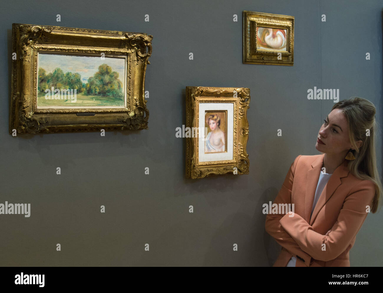 Bonhams, London, February 27th 2017. A woman admires three small paintings by Augustine Renoir including Jeune femme en buste (£150,000-200,000), 'Nu Allongé' (£40,000-80,000) and La party de tennis (£70,000-100,000) at the Bonhams impressionist and modern art sale press preview at their Mayfair gallery in London. Credit: Paul Davey/Alamy Live News Stock Photo