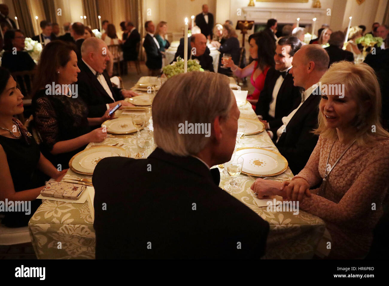 Washington, DC, USA. 26th Feb, 2017. Texas Governor Greg Abbott (back to camera), Maryland Governor Larry Hogan and other sit together during the annual Governors Dinner in the East Room of the White House February 26, 2017 in Washington, DC, USA. Part of the National Governors Association's annual meeting in the nation's capital, the black tie dinner and ball is the first formal event the Trumps will host at the White House since moving in last month. Credit: dpa picture alliance/Alamy Live News Stock Photo