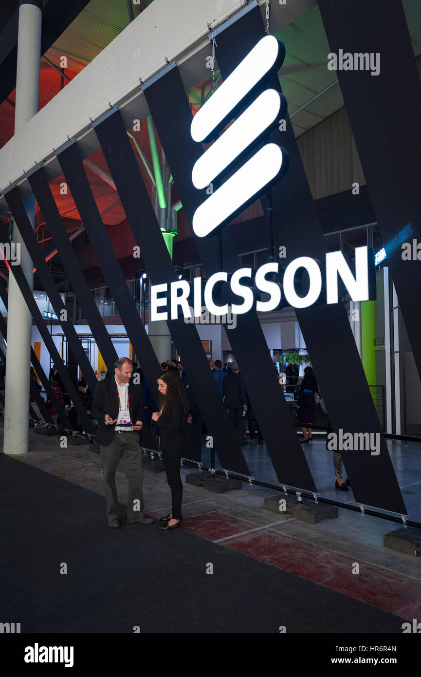Barcelona, Spain. 27th Feb, 2017. Some visitors share information at the entrance of the Ericsson booth during the Mobile World Congress wireless show in Barcelona. The annual Mobile World Congress hosts some of the world's largest communications companies, with many unveiling their latest phones and wearables gadgets. Credit: Charlie Perez/Alamy Live News Stock Photo
