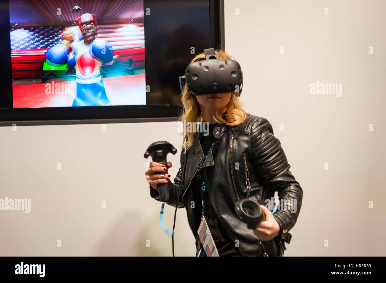 Barcelona, Spain. 27th Feb, 2017. A girl testing a HTC glasses during the Mobile World Congress wireless show in Barcelona. The annual Mobile World Congress hosts some of the world's largest communications companies, with many unveiling their latest phones and wearables gadgets. Credit: Charlie Perez/Alamy Live News Stock Photo