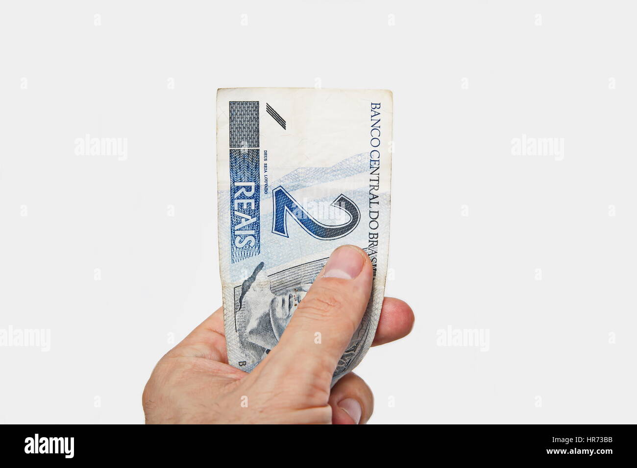 Male hand holding National currency of Brazil. Stock Photo