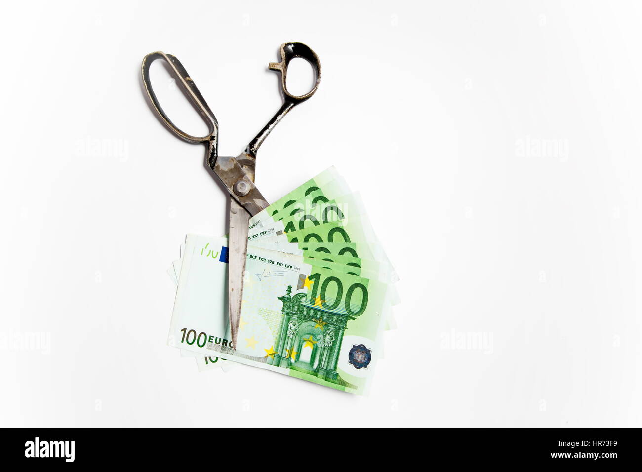Scissors cuts euro banknote on white background Stock Photo