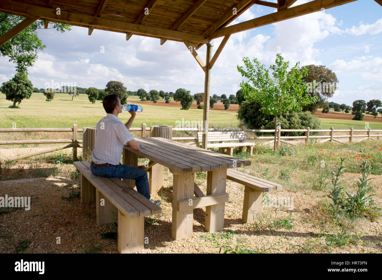 Man taking a rest and drinking ater in the countryside. Toledo province, Castilla La Mancha, Spain. Stock Photo