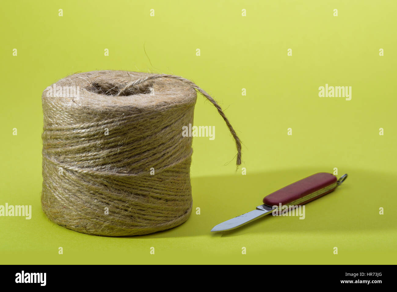 Roll of garden twine with penknife Stock Photo