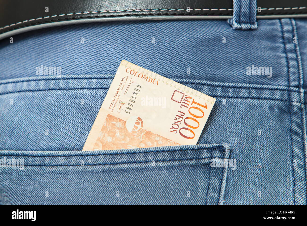 Colombian Pesos in jeans pocket Stock Photo