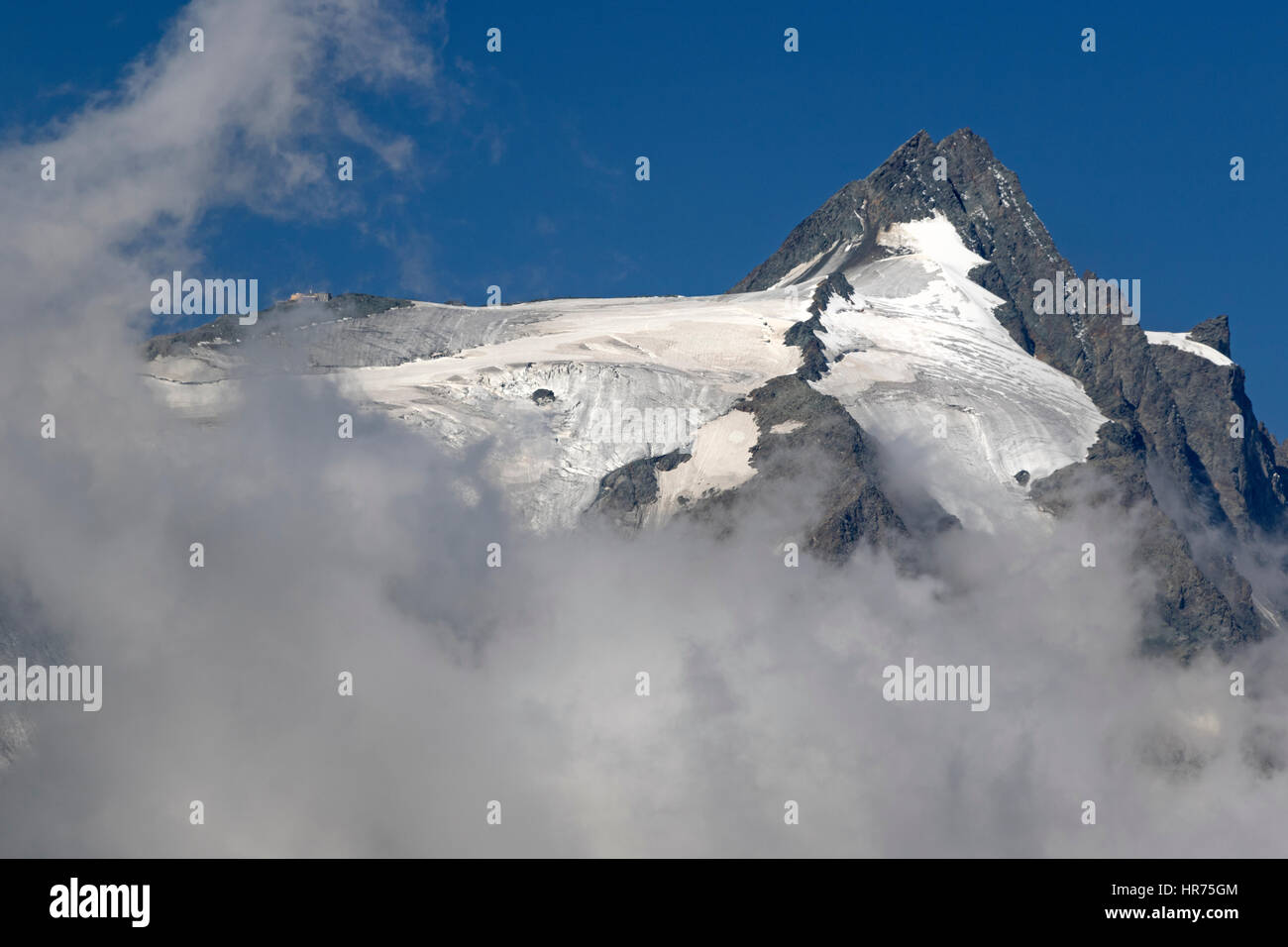 Summit of Mt. Grossglockner with clouds, High Tauern National mountain range, Austria, Europe Stock Photo