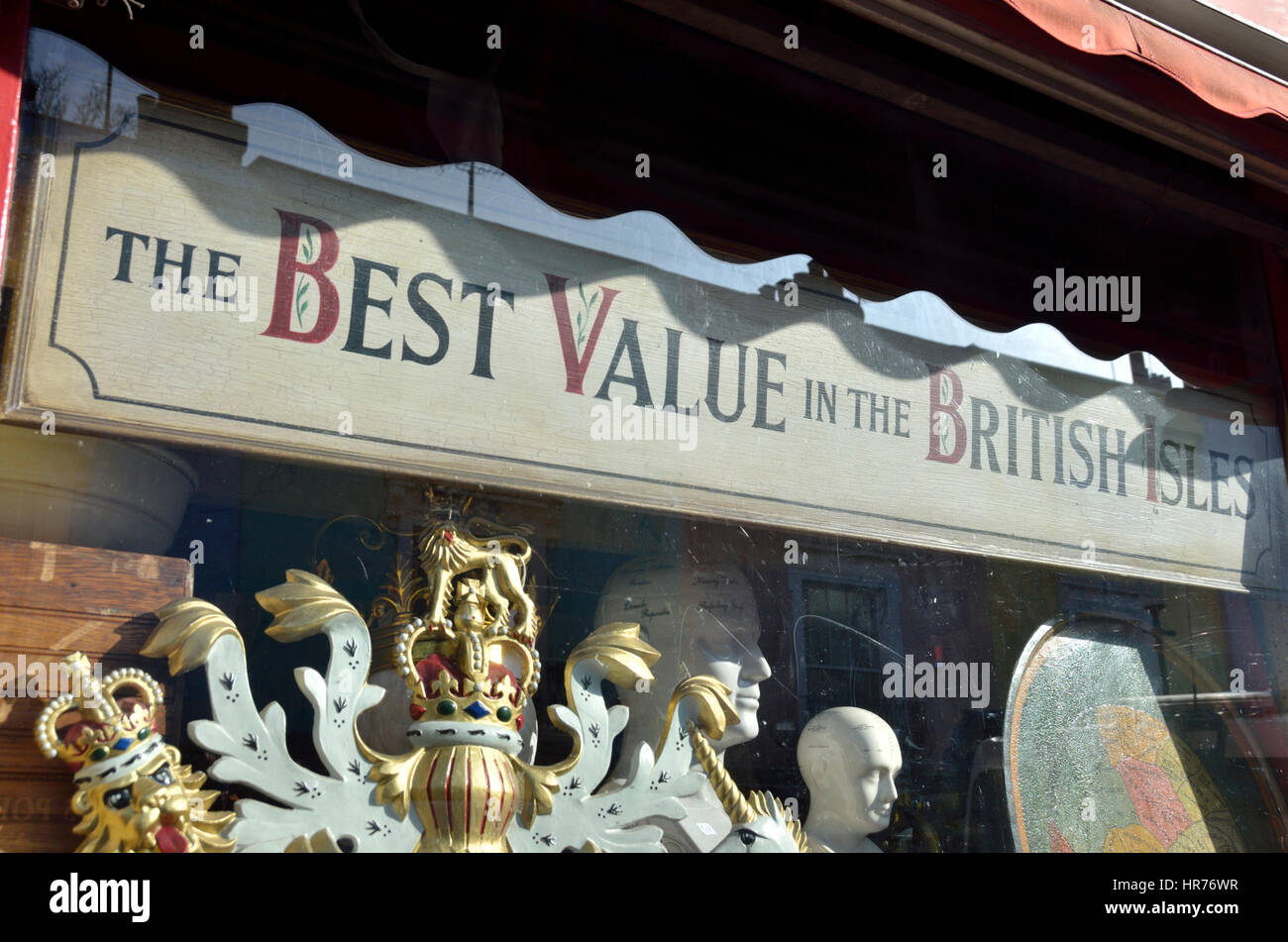 ’The best value in the British Isles’ sign in an antique shop window Stock Photo