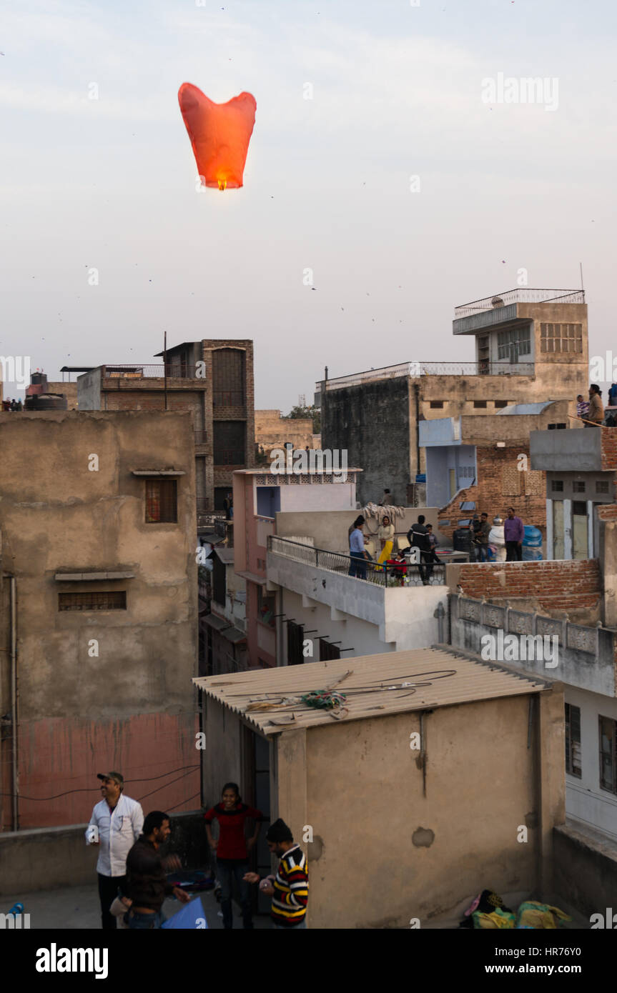 Jaipur, India - 14th Jan 2017: People release a chinese lantern into the air as part of Makar Sankranti or Uttaryan celebration in Rajasthan India. This is a recent trend Stock Photo