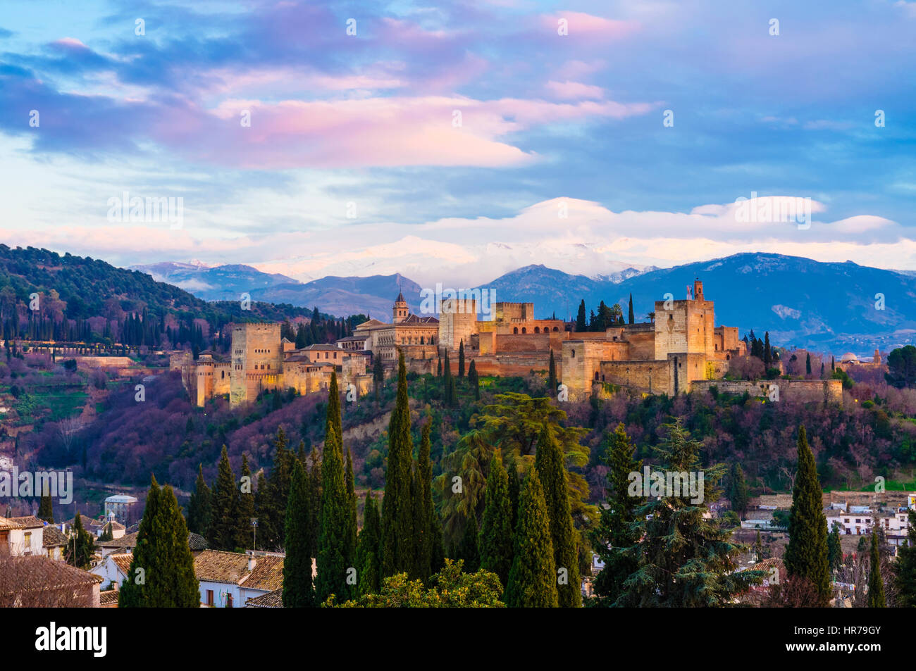 Alhambra palace at sunset with snow-capped Sierra Nevada mountains in background. Granada, Andalusia, Spain Stock Photo