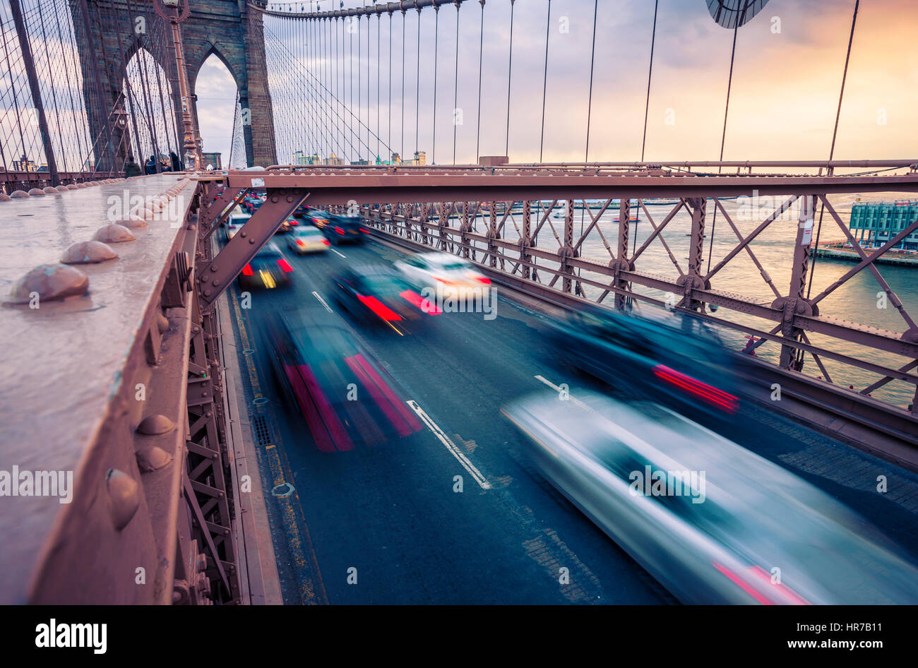 Traffic on Brooklyn Bridge in New York City at sunset Stock Photo