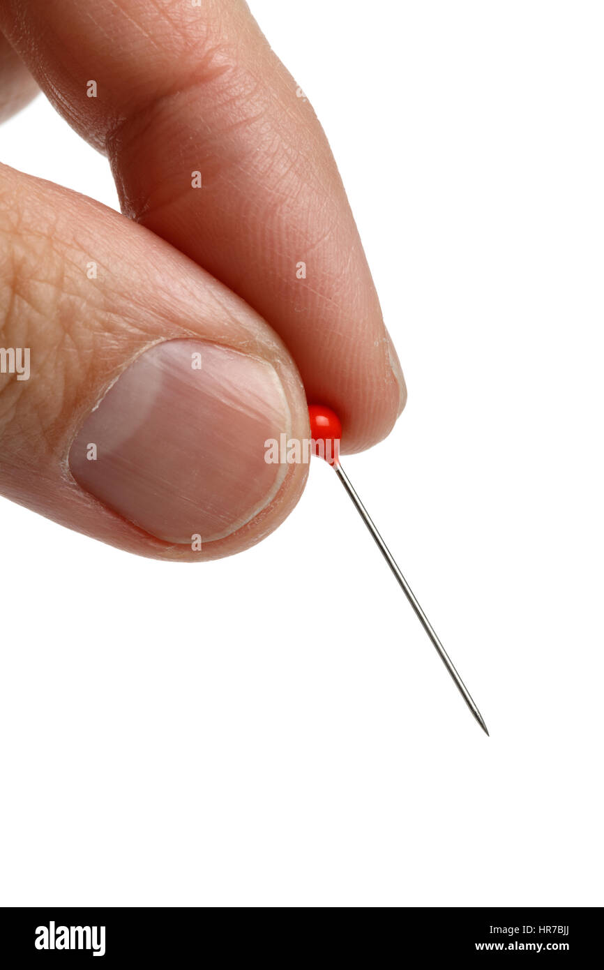 hand holding a pin with a red head, white background Stock Photo - Alamy