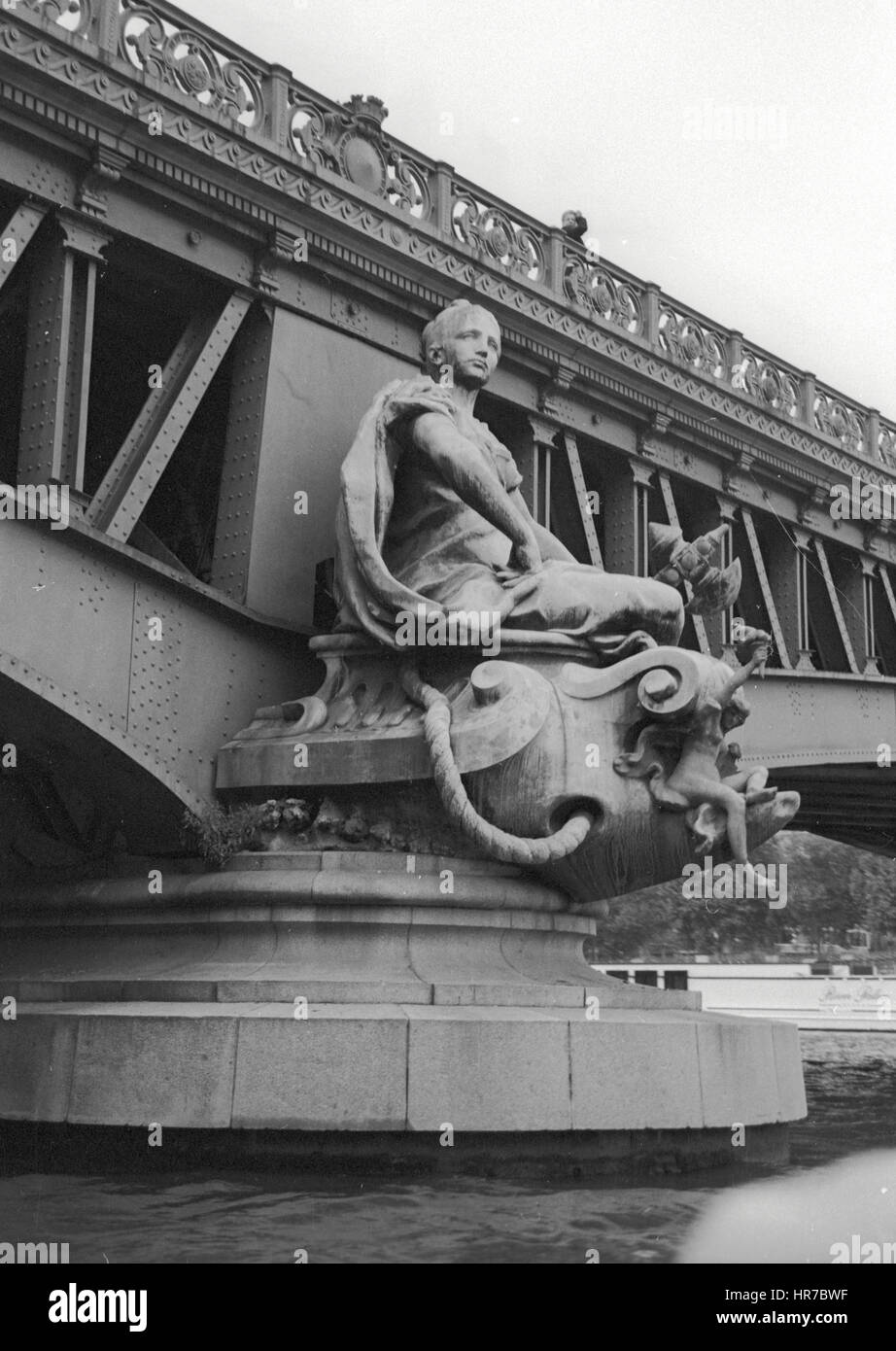 The Mirabeau Bridge over the Seine River feature bronze sculptures on the piles. This figure on the right bank is The City of Paris. Stock Photo