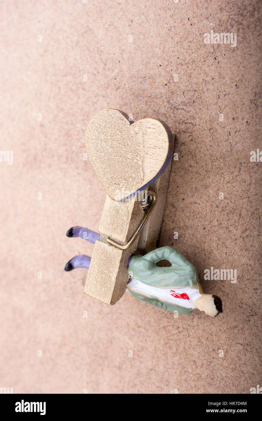 Man figurine trapped in a clothespin on ground Stock Photo Alamy