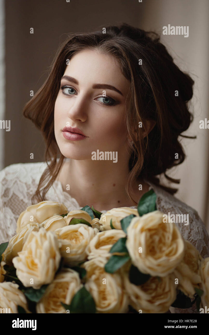 Portrait of a beautiful bride with a bouquet in hands Stock Photo - Alamy