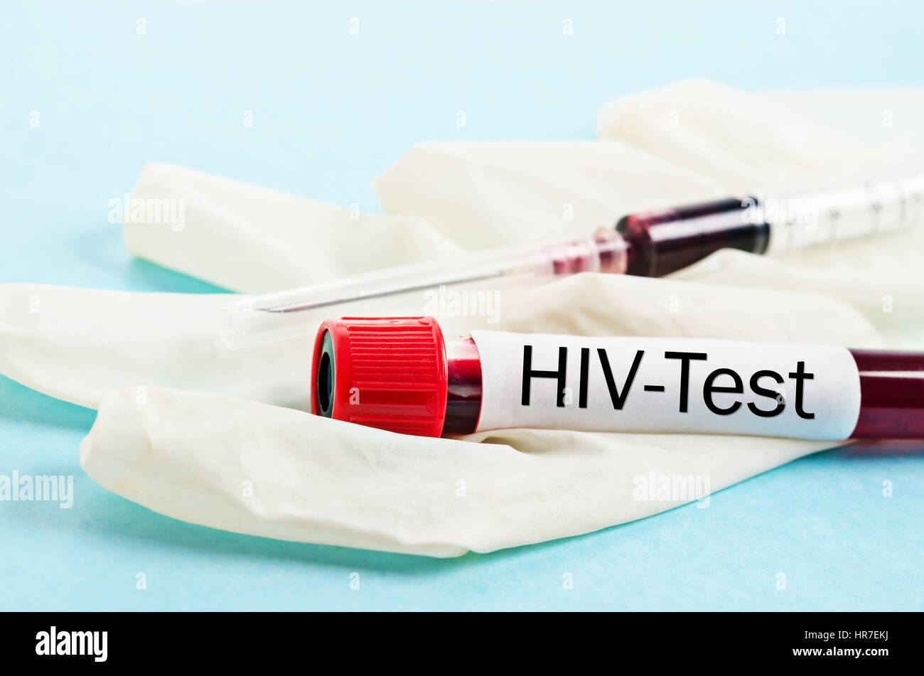 Sample blood collection tube with HIV test label and syringe with glove