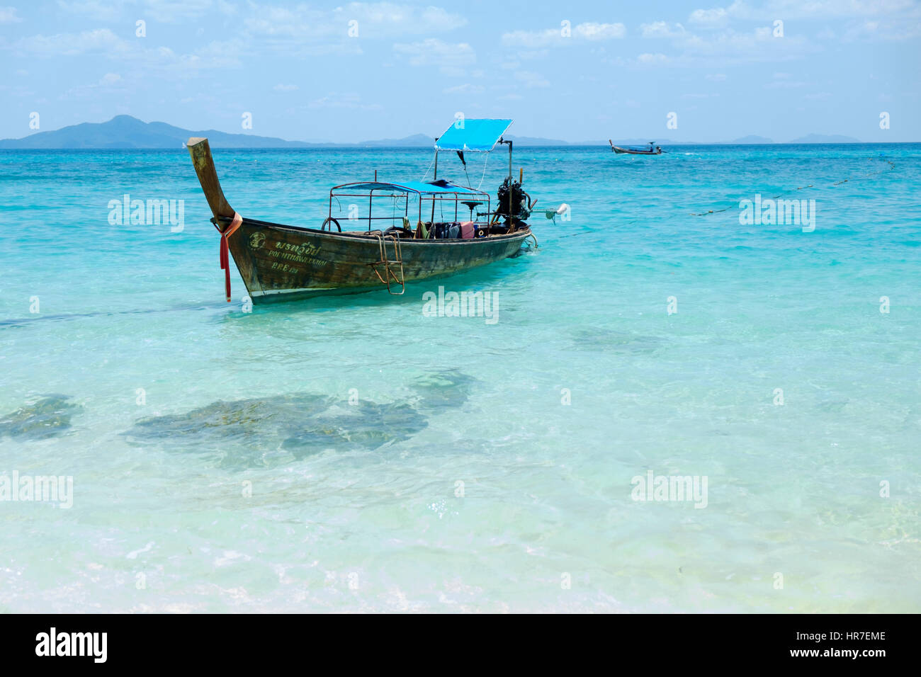A typical Thai long-tail boat off the Andaman Sea coast, Krabi Province, Thailand. Stock Photo