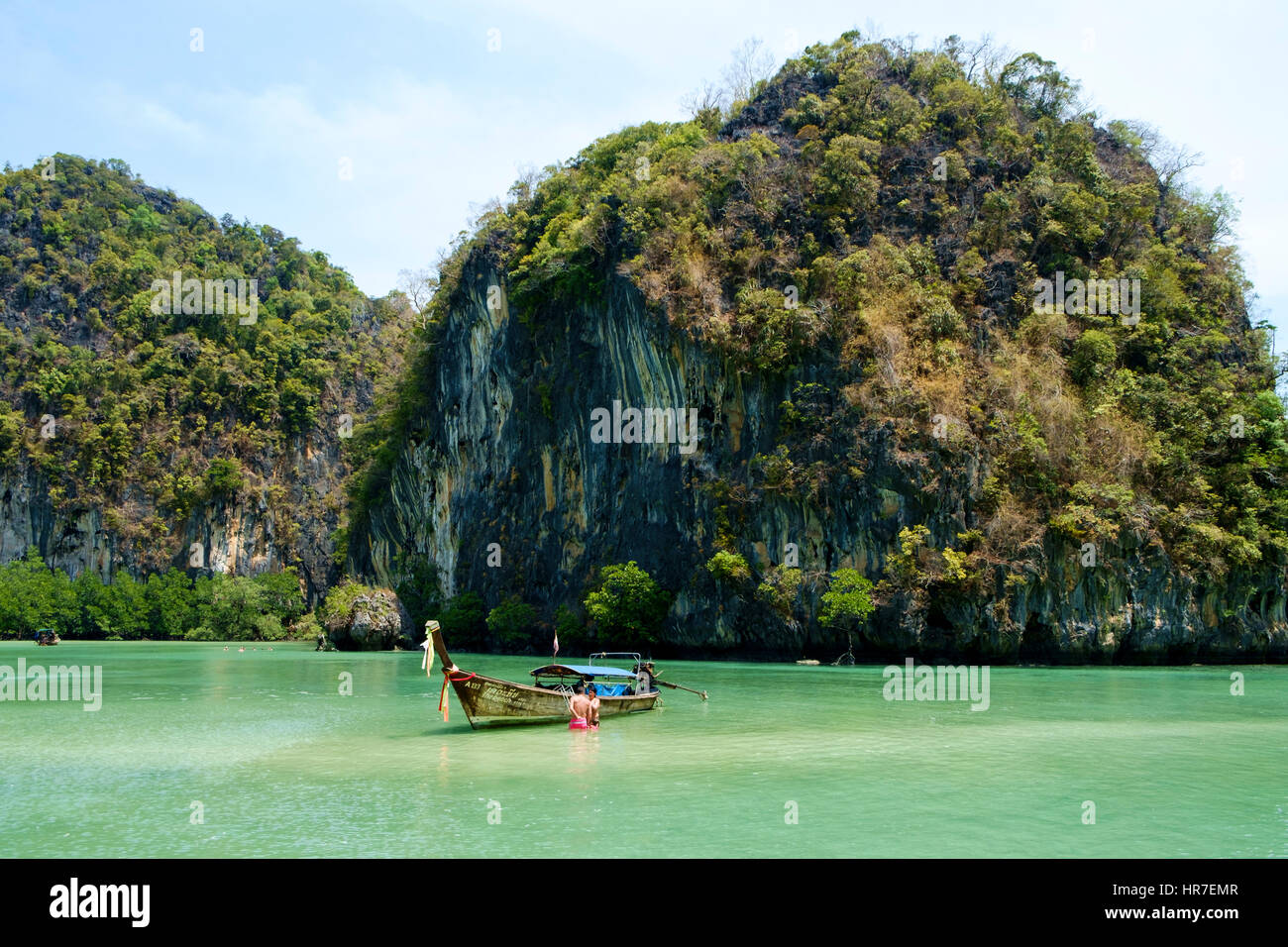 A man and a woman bathing in the karst-surrounded 'emerald lagoon', Koh Hong, Hong Islands, National Marine Park, Phang Nga Bay, Thailand. Stock Photo