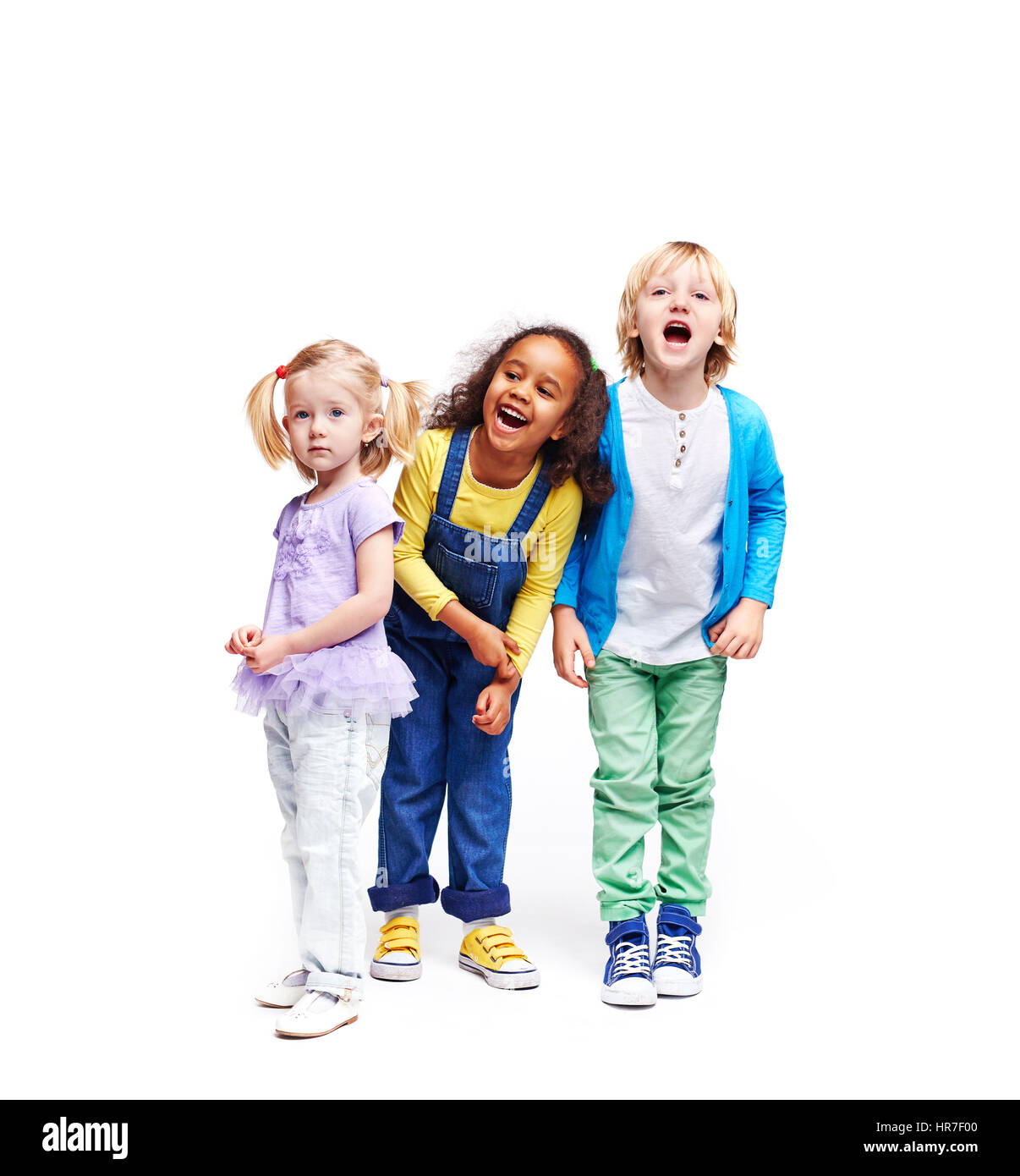 Studio portrait of children against white background:  full body shot of three kids in colorful clothes, African girl, blond boy and cute little girl, Stock Photo