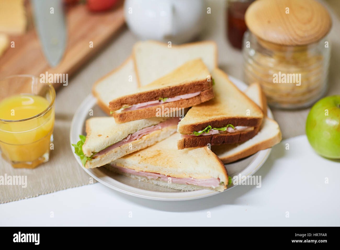Close-up shot of appetizing breakfast prepared for family: sandwiches ...