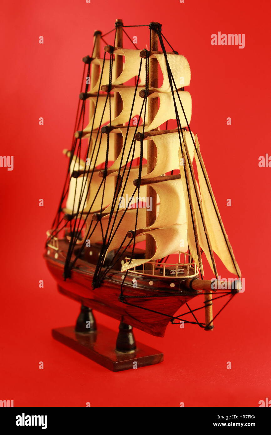 Wood Sailing Ship Handcraft with Red Brackground Stock Photo