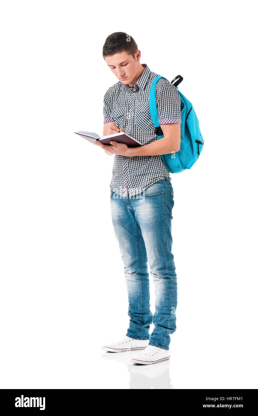Full length portrait of a caucasian guy student of college or university with backpack and notepad. Casual young male - teen boy - isolated white back Stock Photo
