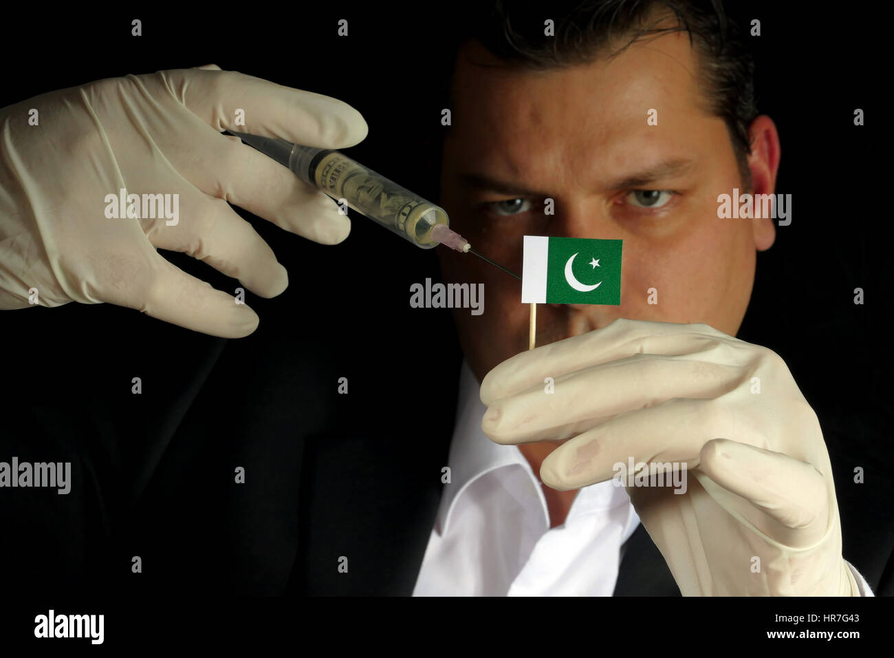Fiscal Injection Young businessman gives a financial injection to Pakistani flag ...