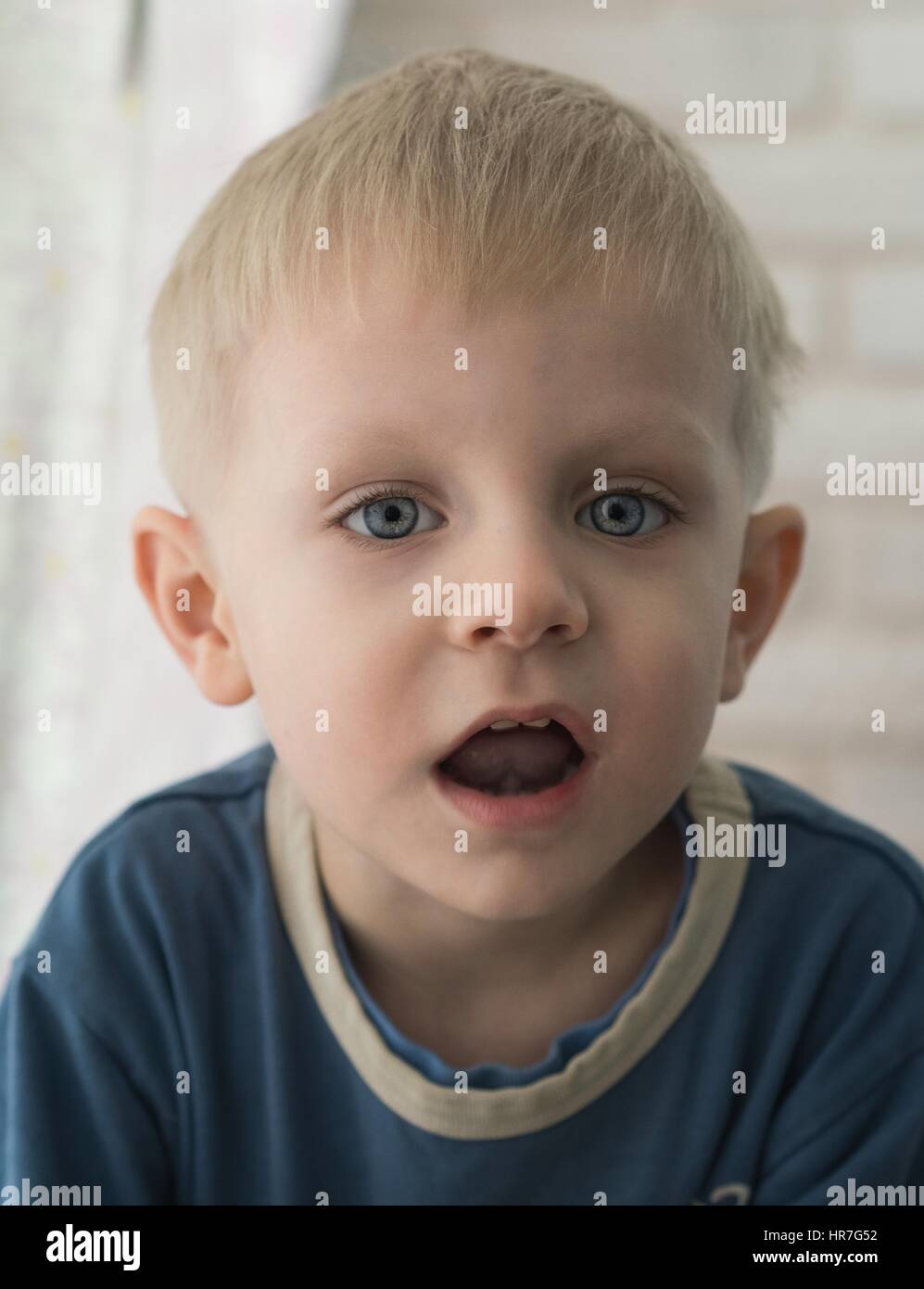 Little Caucasian boy looking at the camera Stock Photo - Alamy