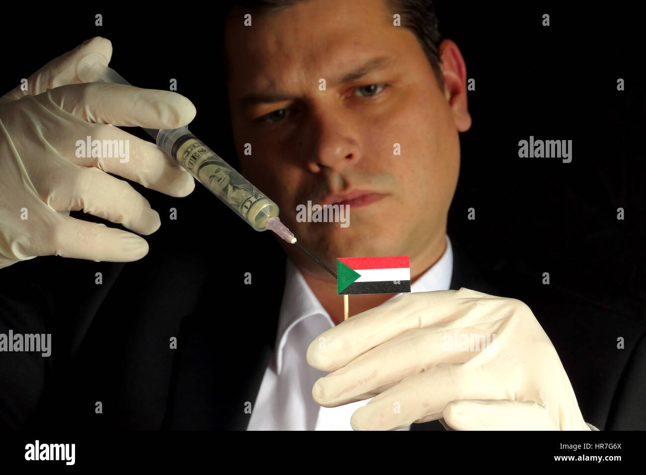 Fiscal Injection Young businessman gives a financial injection to Sudanese flag isolated ...