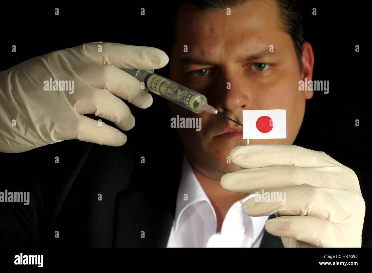 Fiscal Injection Young businessman gives a financial injection to Japanese flag isolated ...