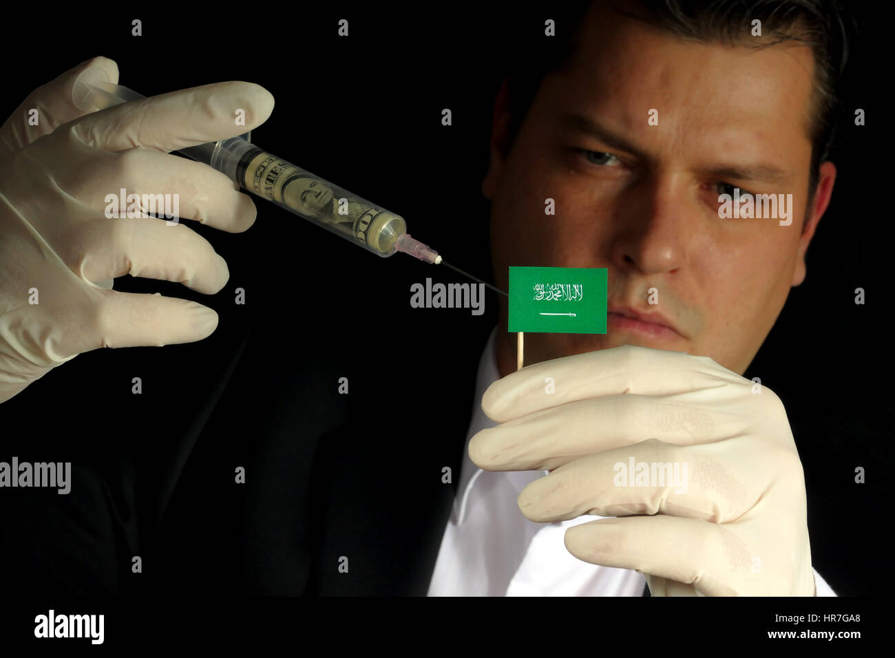 Fiscal Injection Young businessman gives a financial injection to Saudi Arabian flag ...