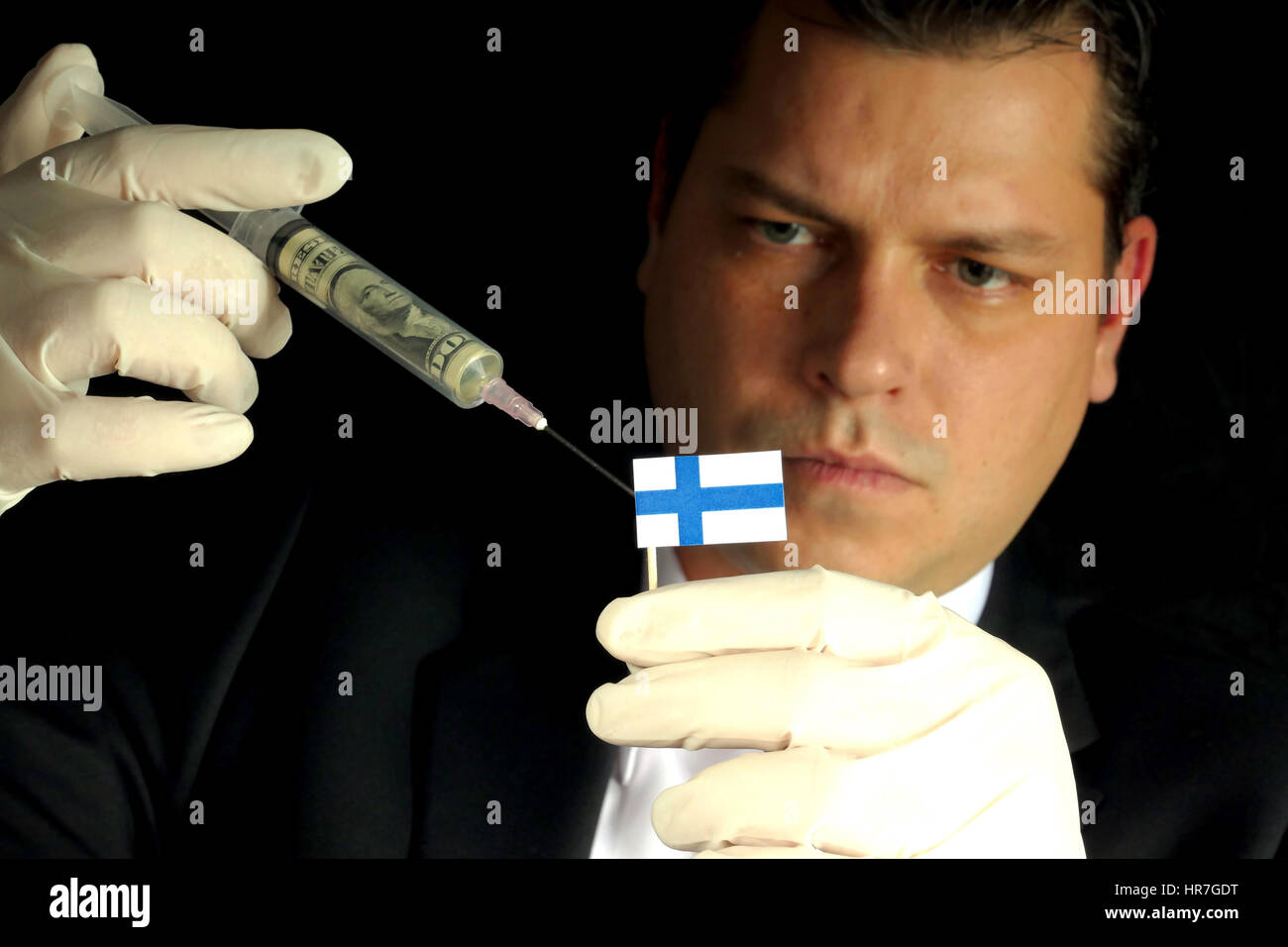 Fiscal Injection Young businessman gives a financial injection to Finnish flag isolated ...