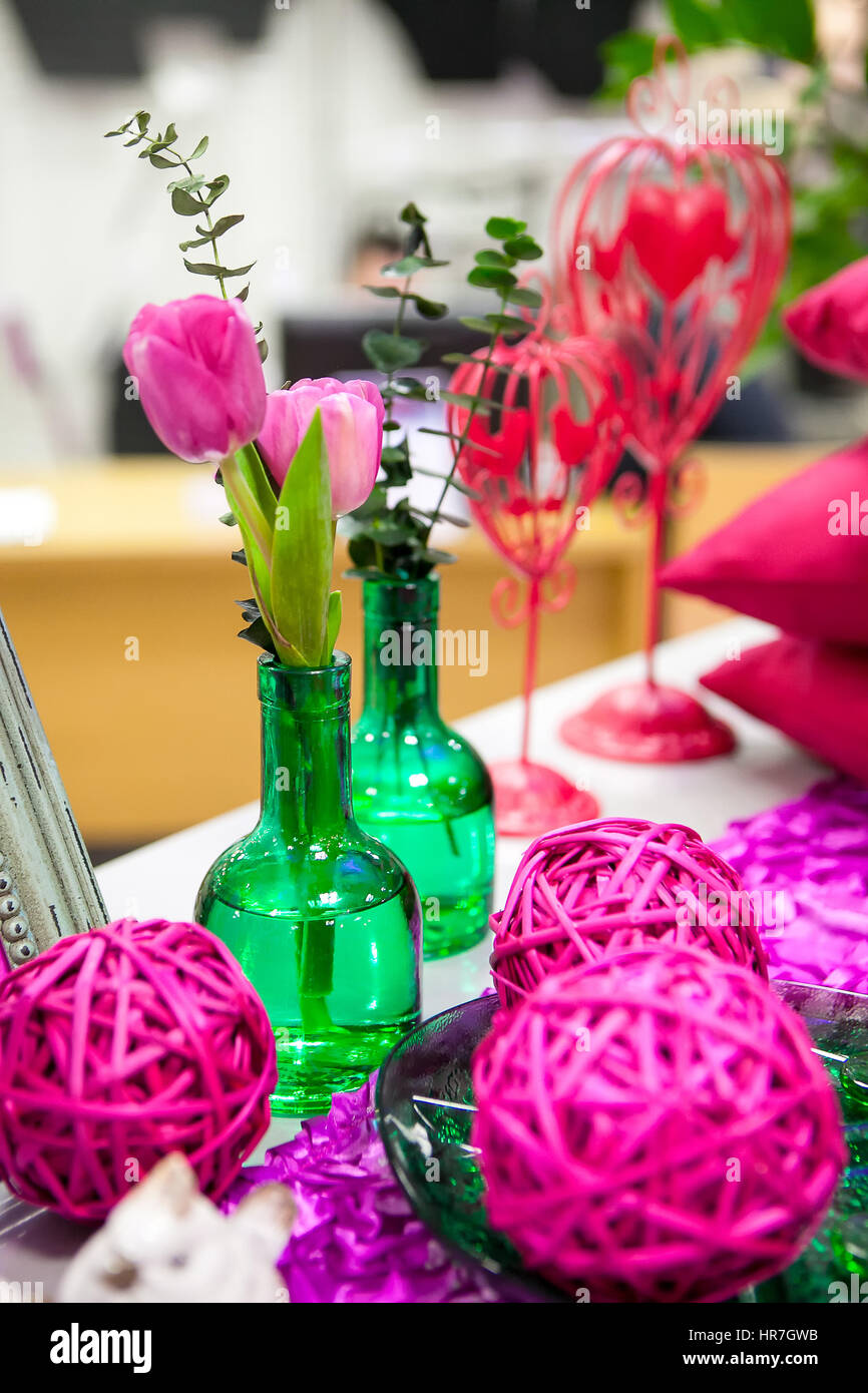 Arrangement of green glass vases and flowers Stock Photo