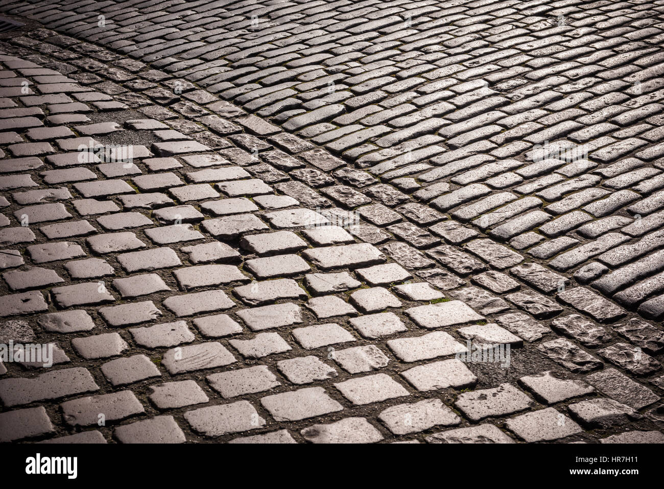 The cobbled pavement outside the Tower of London, polished to a shine by millions of tourists, glints in the early morning sunshine. Stock Photo