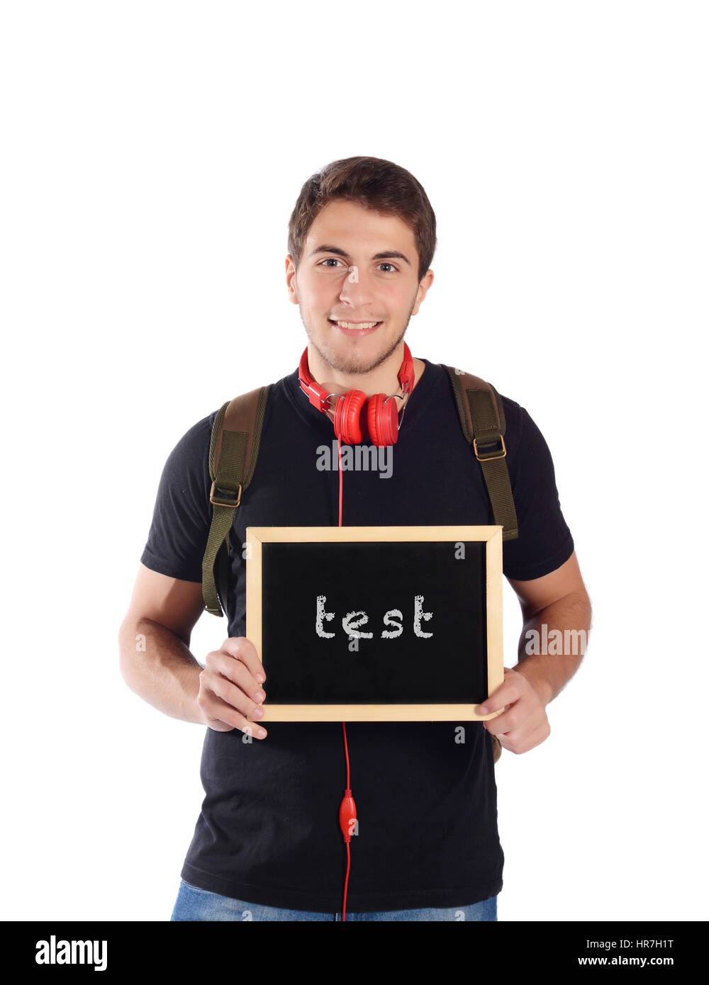 Close up of a young handsome man holding chalkboard with text 'test'. Education concept. Isolated white background. Stock Photo