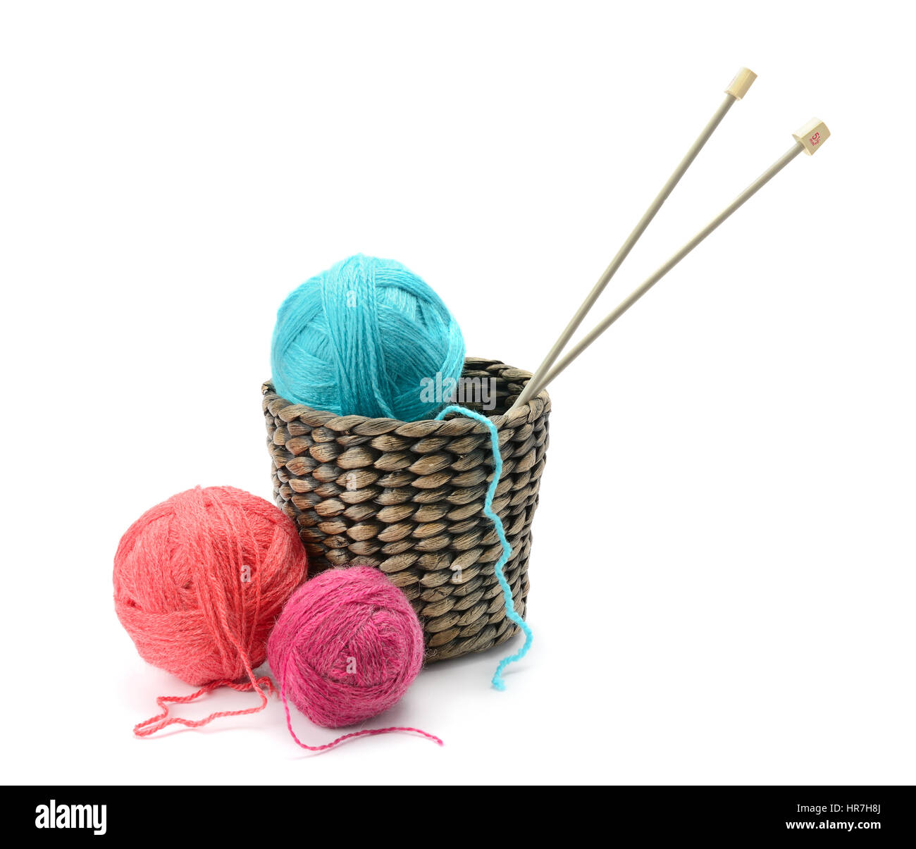 Multicolored balls and needles in basket isolated on white Stock Photo