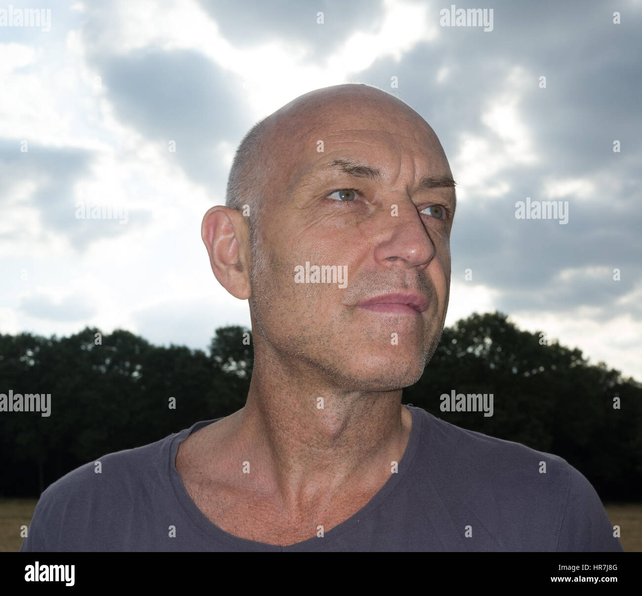 Portrait of a bald happy middle aged men looking sidewise Stock Photo