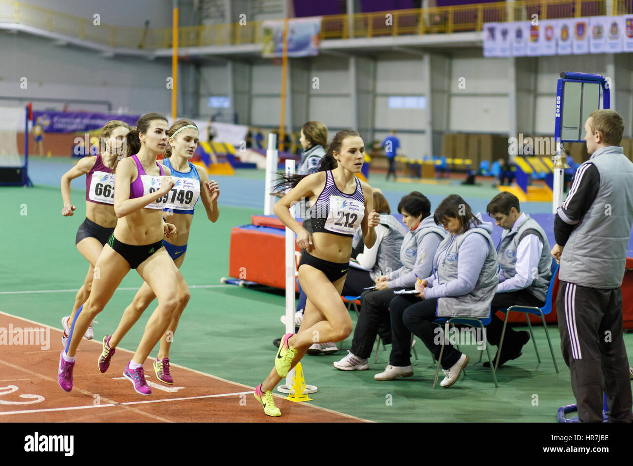 SUMY, UKRAINE - FEBRUARY 17, 2017: Mariya Shatalova (212), Olena Sokur (889), Viktoria Khapilina (662) and Nataliia Strebkova (749) running in final of 3000m race on Ukrainian indoor track and field championship 2017 Stock Photo